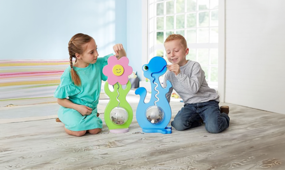 two children playing with big belly banks
