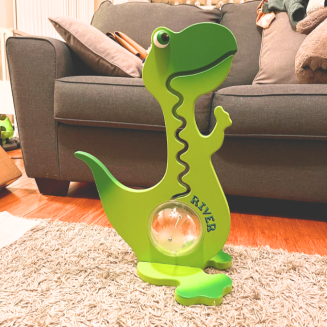 Green dinosaur-shaped piggy bank personalized with custom name gift for kids