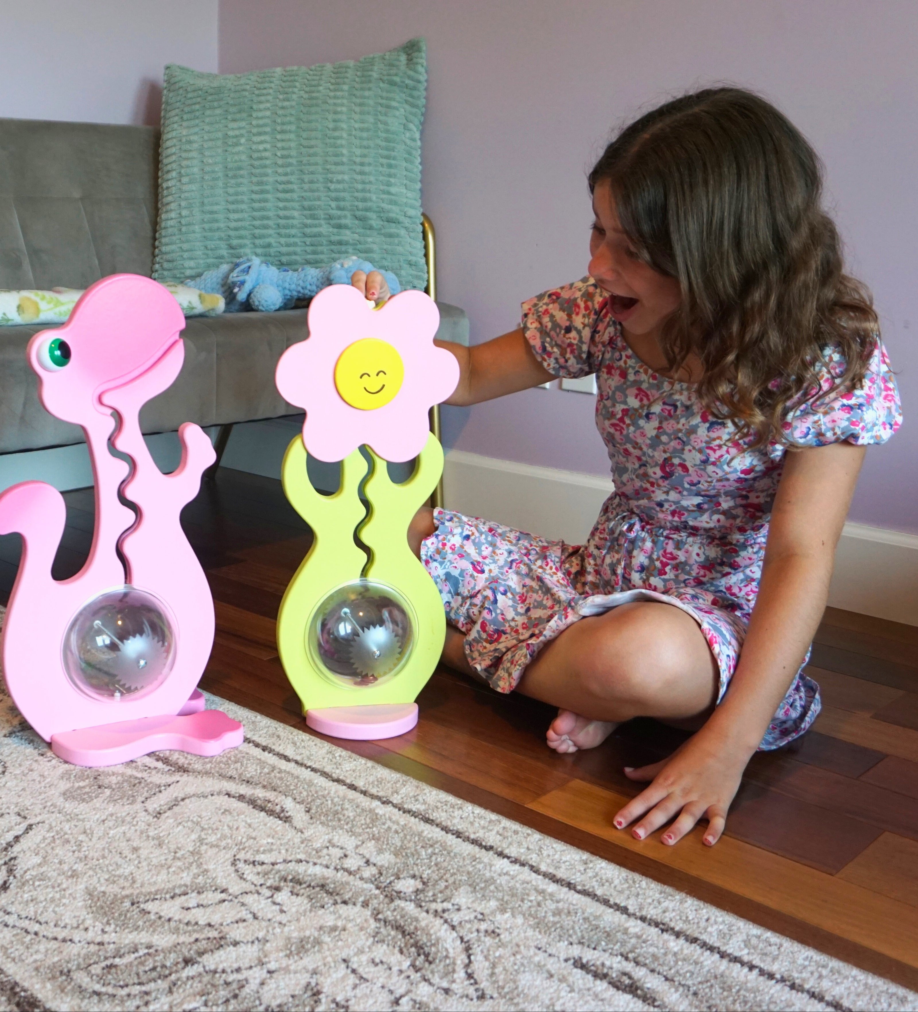Child playing with colorful toys on a wooden floor